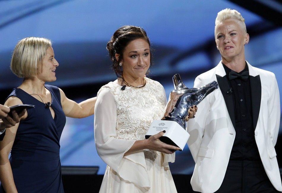 Wolfsburgs Nadine Kessler C displays her Best Player Womens Player UEFA 2014 Award during the draw ceremony for the 20142015 Champions League soccer competition at Monacos Grimaldi Forum in Monte Carlo August 28, 2014. Kessler poses with Martina Mul