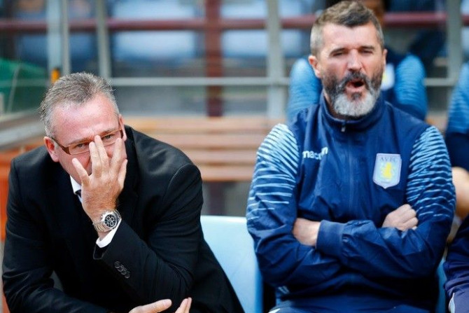 Aston Villa manager Paul Lambert (L) and his assistant Roy Keane sits in the dugout before their English Premier League soccer match against Newcastle United at Villa Park in Birmingham, central England August 23, 2014.