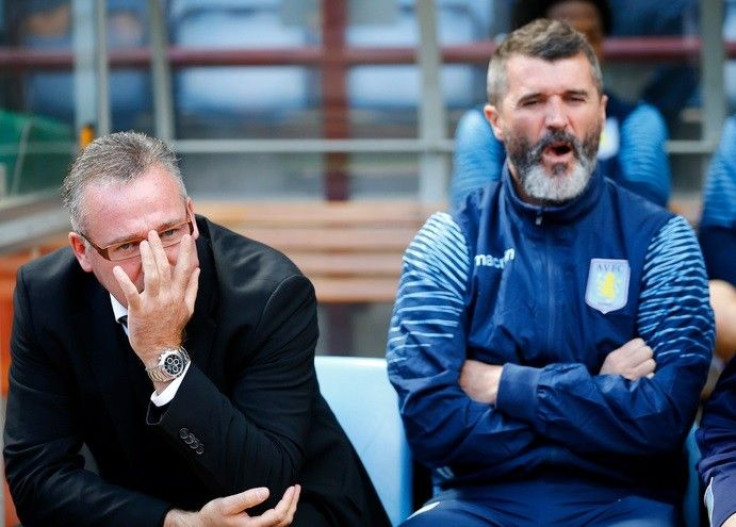 Aston Villa manager Paul Lambert (L) and his assistant Roy Keane sits in the dugout before their English Premier League soccer match against Newcastle United at Villa Park in Birmingham, central England August 23, 2014.