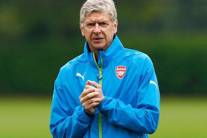 Arsenal manager Arsene Wenger attends a team training session at their training ground in London Colney, north of London, August 26, 2014. Arsenal are due to play Besiktas in a Champions League qualifying soccer match on Wednesday in London.
