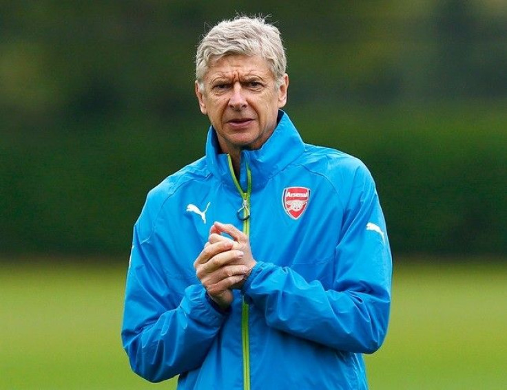 Arsenal manager Arsene Wenger attends a team training session at their training ground in London Colney, north of London, August 26, 2014. Arsenal are due to play Besiktas in a Champions League qualifying soccer match on Wednesday in London.