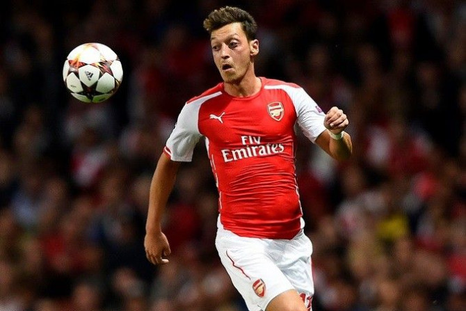 Arsenal's Mesut Ozil runs for the ball during their Champions League playoff soccer match against Besiktas at the Emirates stadium in London August 27, 2014.