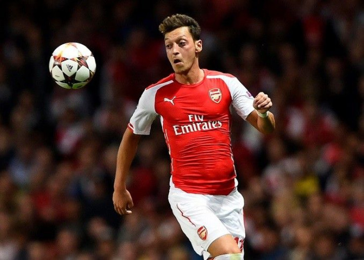 Arsenal's Mesut Ozil runs for the ball during their Champions League playoff soccer match against Besiktas at the Emirates stadium in London August 27, 2014.