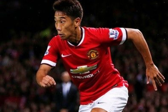 Manchester United&#039;s Shinji Kagawa runs with ball during their friendly soccer match against Valencia at Old Trafford in Manchester, northern England August 12, 2014.