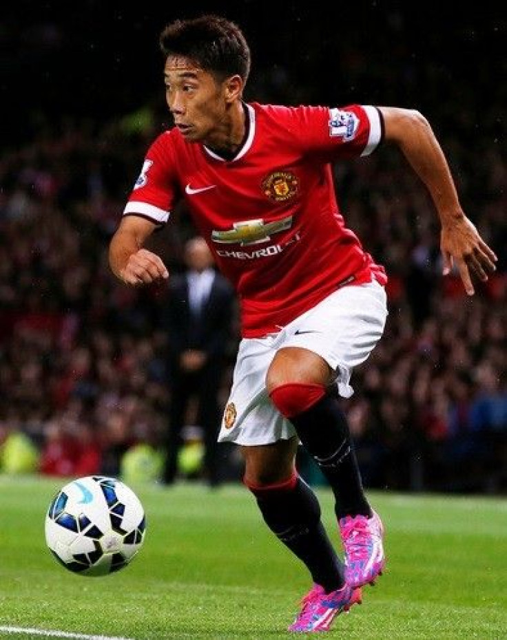 Manchester United&#039;s Shinji Kagawa runs with ball during their friendly soccer match against Valencia at Old Trafford in Manchester, northern England August 12, 2014.