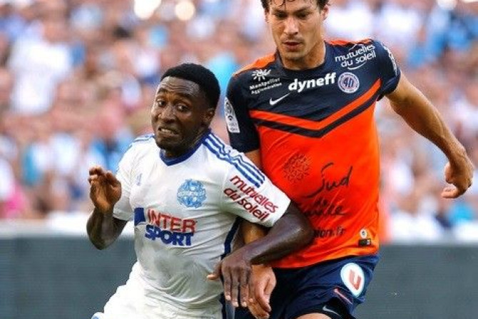 Olympique Marseille&#039;s Brice Dja Djejde (L) challenges Benjamin Stambouli of Montpellier during their French Ligue 1 soccer match at the Velodrome Stadium in Marseille, August 17, 2014.