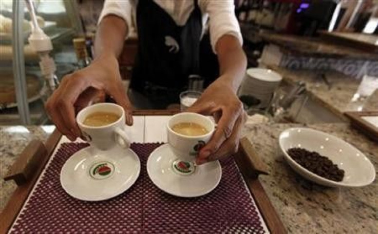 A waitress serves coffee to customers at a coffee bar in Sao Paulo