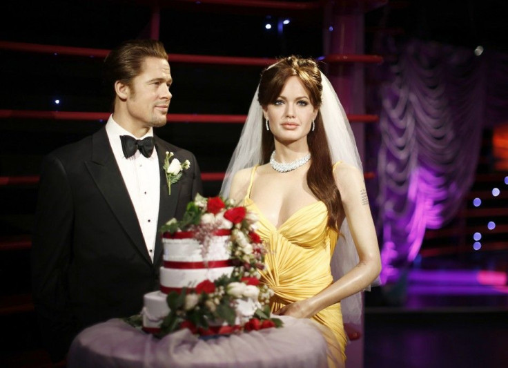 Wax Models Of Actors Brad Pitt And Angelina Jolie Are Pictured With A wedding Cake And A Bridal Veil In Celebration Of Their Recent Wedding.