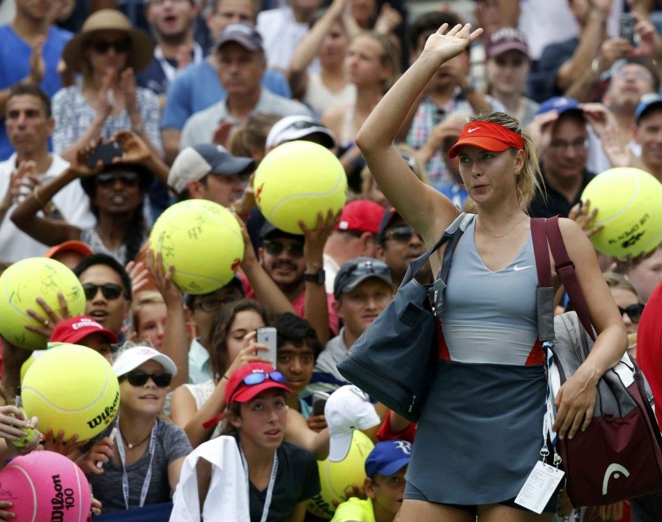 Maria Sharapova of Russia waves to the crowd after being defeated by Caroline Wozniacki of Denmark during their match at the 2014 U.S. Open tennis tournament in New York, August 31, 2014. REUTERSRay Stubblebine