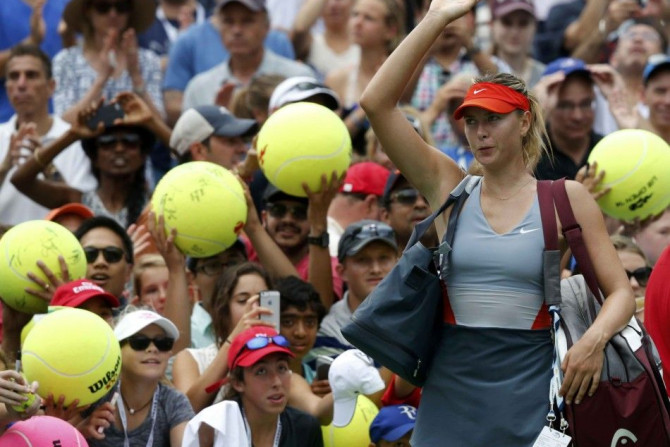 Maria Sharapova of Russia waves to the crowd after being defeated by Caroline Wozniacki of Denmark during their match at the 2014 U.S. Open tennis tournament in New York, August 31, 2014. REUTERS/Ray Stubblebine