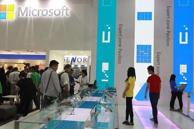 People visit the Microsoft booth during the 2014 Computex exhibition at the TWTC Nangang exhibition hall in Taipei June 3, 2014