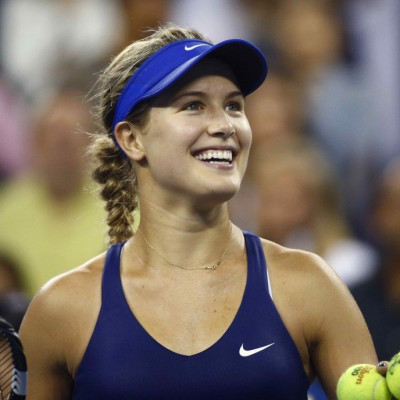 Eugenie Bouchard of Canada smiles as she hits a ball into the crowd after defeating Barbora Zahlavova Strycova of the Czech Republic after their women's singles match at the 2014 U.S. Open tennis tournament in New York August 30, 2014. REUTERS/Adam Hunger