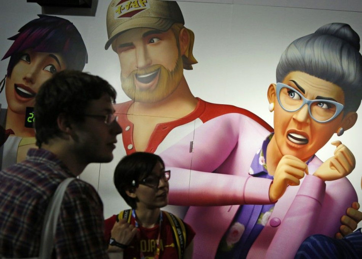 People Stand Near 'Sims 4' Game Characters On A Wall During The 2014 Electronic Entertainment Expo, Known As E3, In Los Angeles