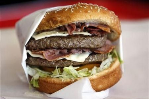 A hamburger sits on a corner.