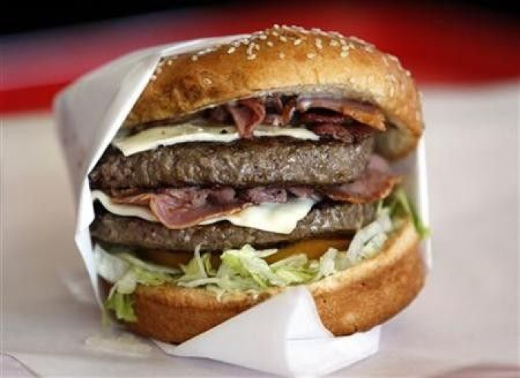 A hamburger sits on a corner.
