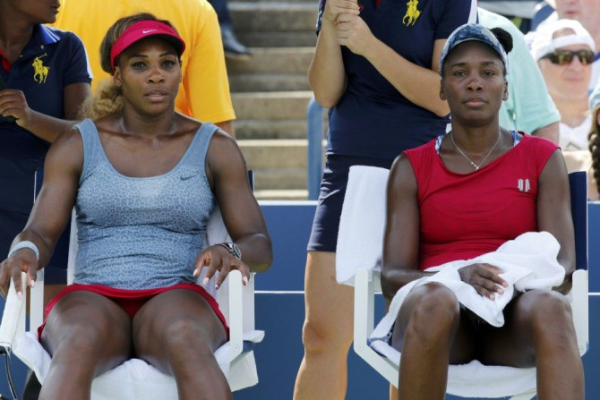 Serena (L) and Venus Williams of the U.S. react after their loss to Ekaterina Makarova and Elena Vesnina of Russia in their quarter-final doubles match at the 2014 U.S. Open tennis tournament in New York, September 2, 2014.