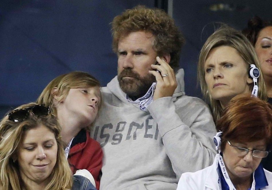 Actor Will Ferrell listens to a radio as he watches an evening match with his son and wife Viveca Paulin R at the 2014 U.S. Open tennis tournament in New York, August 29, 2014. REUTERSShannon Stapleton