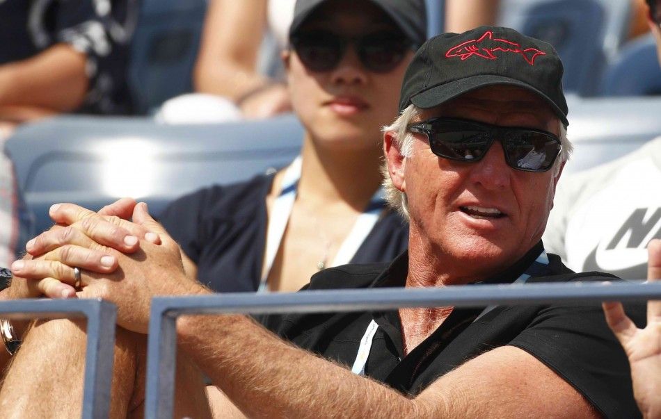 Golfer Greg Norman of Australia watches the fourth round match between Grigor Dimitrov of Bulgaria and Gael Monfils of France at the 2014 U.S. Open tennis tournament in New York, September 2, 2014. REUTERSAdam Hunger
