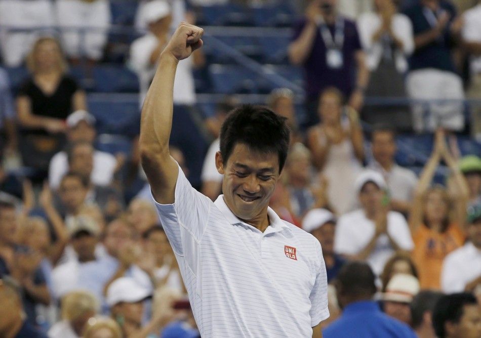 Kei Nishikori of Japan celebrates after defeating Stan Wawrinka of Switzerland