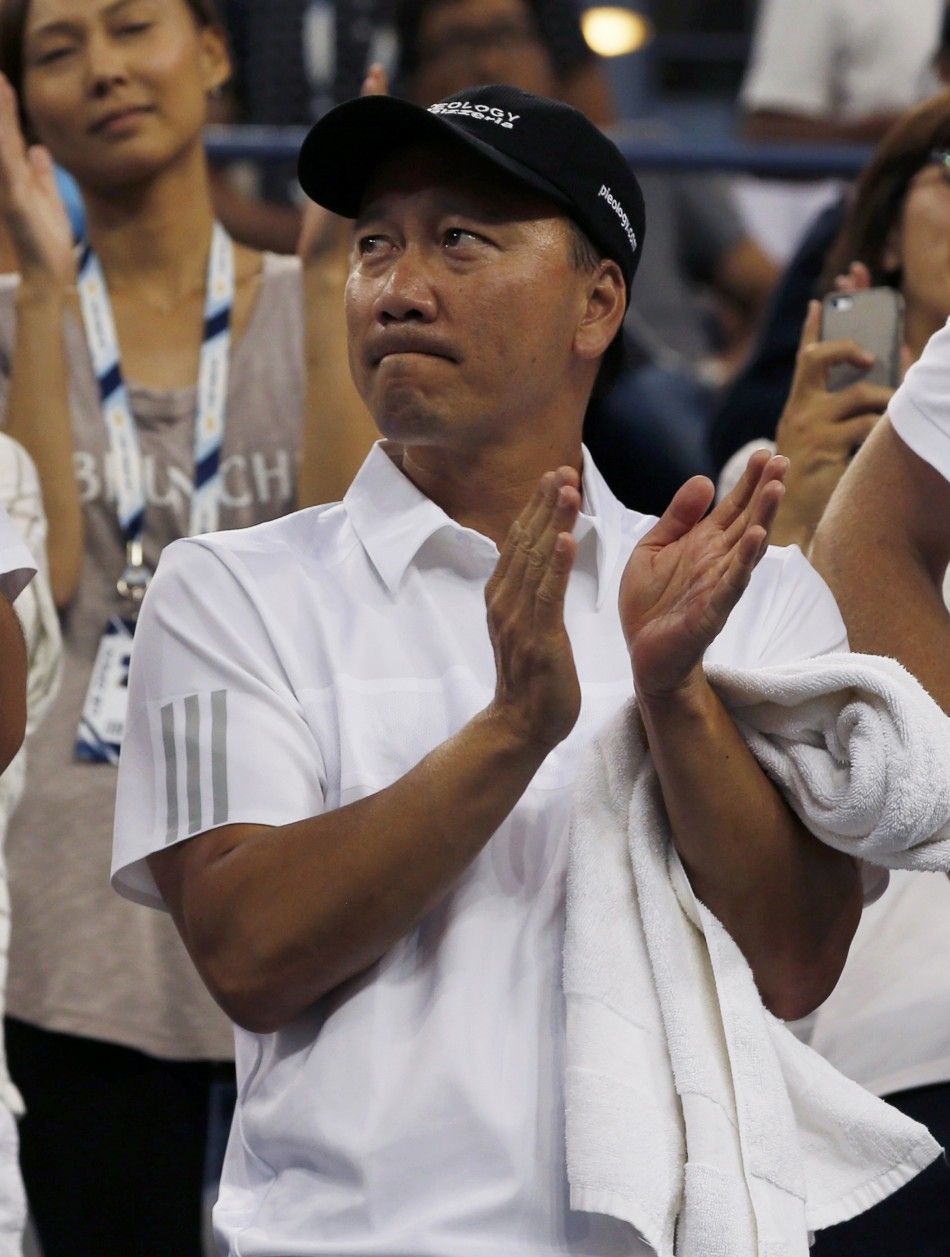 Michael Chang, coach of Kei Nishikori of Japan, applauds after Nishikori defeated Stan Wawrinka of Switzerland