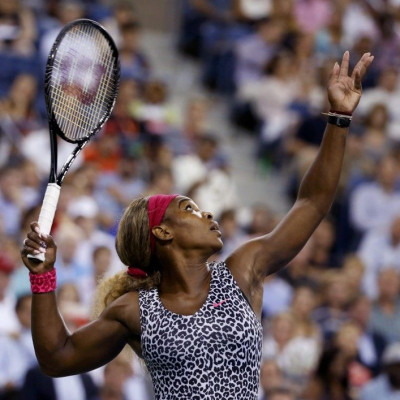 Serena Williams of the U.S. serves to Flavia Pennetta of Italy in their quarter-final women&#039;s singles match at the 2014 U.S. Open tennis tournament in New York, September 3, 2014.