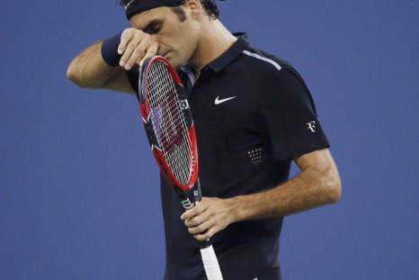 Roger Federer of Switzerland wipes sweat away