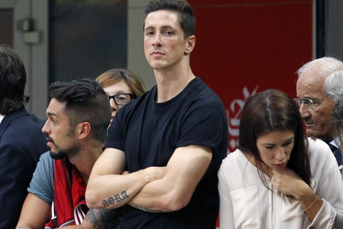 AC Milan's newly signed player Fernando Torres (C) watches their Italian Serie A soccer match against Lazio at the San Siro stadium in Milan August 31, 2014.