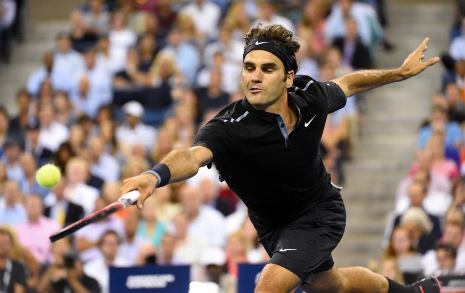 Roger Federer SUI returns a shot to Gael Monfils FRA