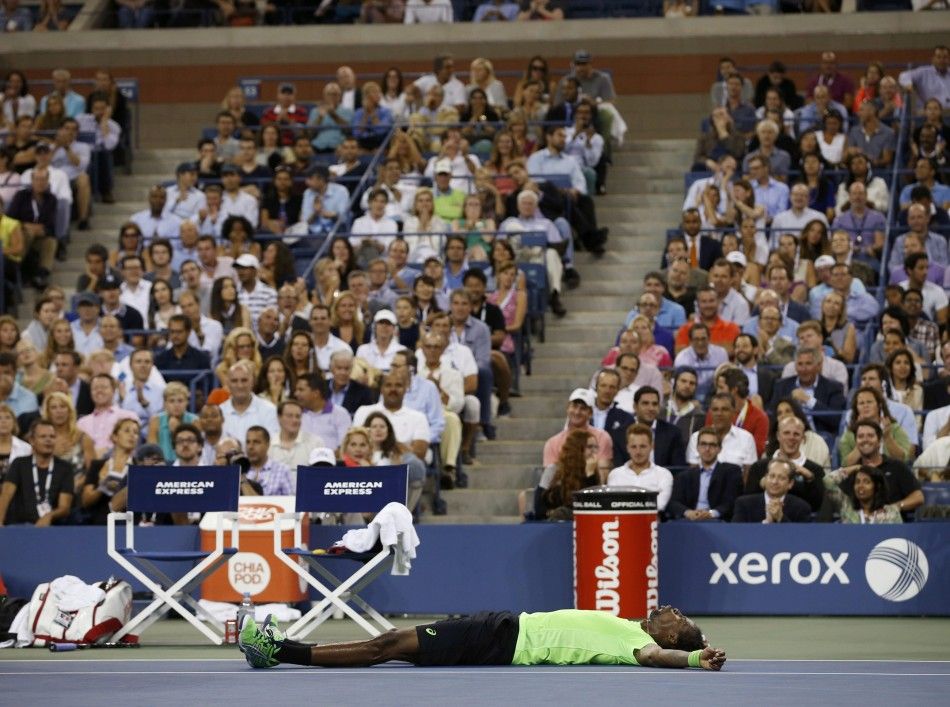 Gael Monfils of France lays on the court