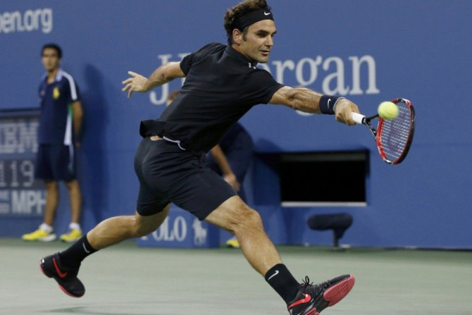 Roger Federer of Switzerland reaches to make a fourth set