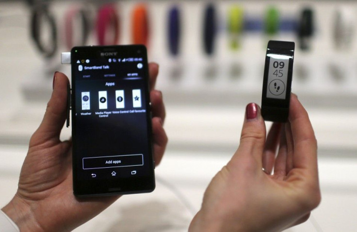 A Sony employee holds a Sony Xperia Z3 and a Sony Smartband Talk during the IFA Electronics show in Berlin September 4, 2014