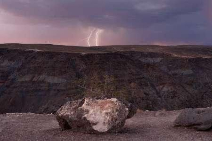 Lightning strikes near a ridge as a storm passes
