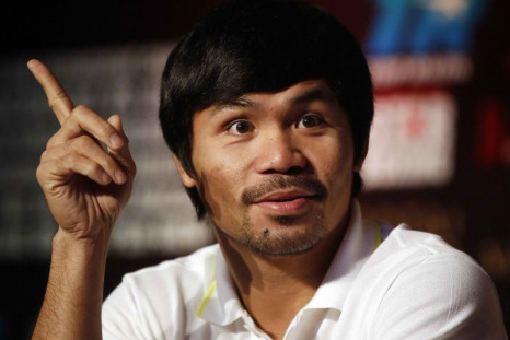 Manny Pacquiao of the Philippines attends a promotional event with his next opponent Chris Algieri of the U.S. (not pictured) at a hotel in downtown Shanghai August 26, 2014. Pacquiao will defend his WBO welterweight title against Algieri at the Venetian&