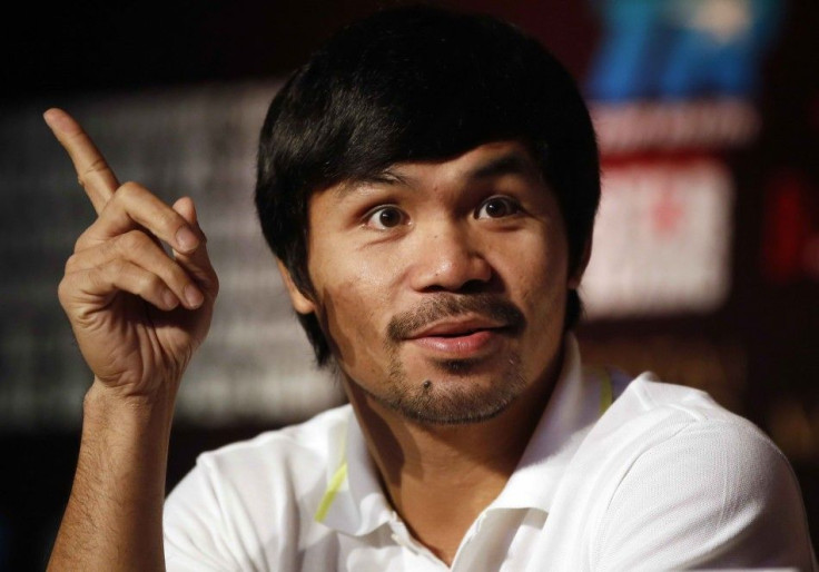 Manny Pacquiao of the Philippines attends a promotional event with his next opponent Chris Algieri of the U.S. (not pictured) at a hotel in downtown Shanghai August 26, 2014. Pacquiao will defend his WBO welterweight title against Algieri at the Venetian&