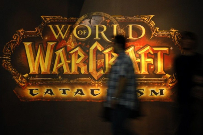 A Visitor Walks Past A Placard of &#039;World of Warcraft&#039; At Their Exhibition Stand At The Gamescom 2010 Fair.