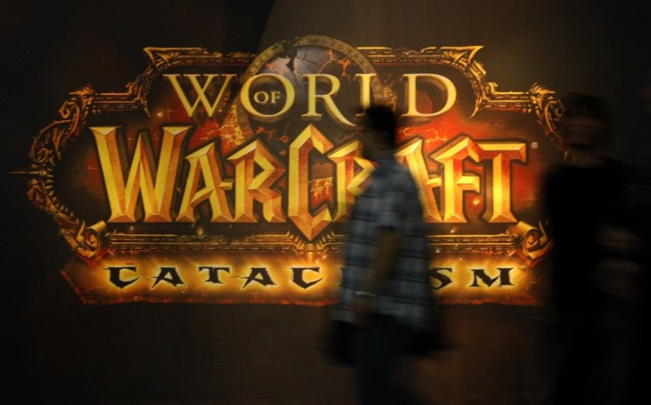 A Visitor Walks Past A Placard of &#039;World of Warcraft&#039; At Their Exhibition Stand At The Gamescom 2010 Fair.