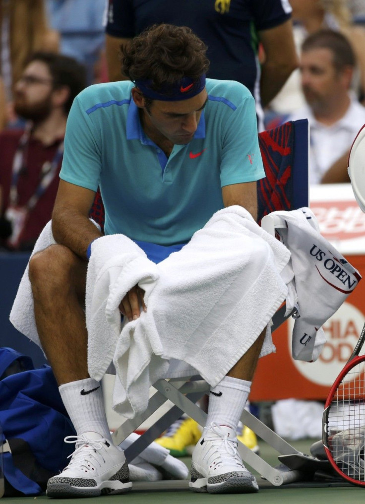 Roger Federer of Switzerland reacts during a break in the last set of the semi-final match against Marin Cilic of Croatia at the 2014 U.S. Open tennis tournament in New York, September 6, 2014