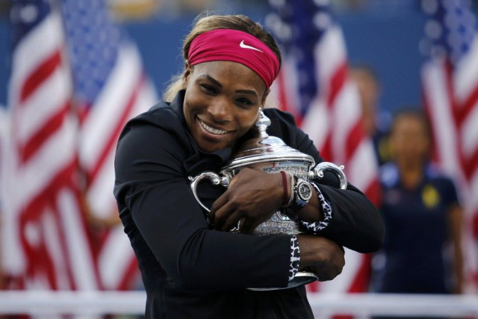 Serena Williams of the U.S. embraces her trophy after defeating Caroline Wozniacki of Denmark