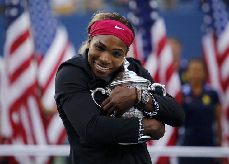Serena Williams of the U.S. embraces her trophy after defeating Caroline Wozniacki of Denmark