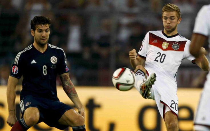 Germany's Christoph Kramer (R) and Scotland's Charlie Mulgrew fight for the ball during their Euro 2016 qualifying soccer match in Dortmund September 7, 2014.