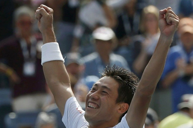 Kei Nishikori of Japan celebrates after defeating Novak Djokovic of Serbia