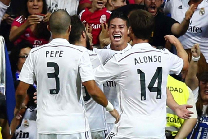 Real Madrid&#039;s James Rodriguez (C) is congratulated by teammates after scoring a goal against Atletico Madrid during their Spanish Super Cup first leg soccer match at Santiago Bernabeu stadium in Madrid August 20, 2014. REUTERS/Sergio Perez
