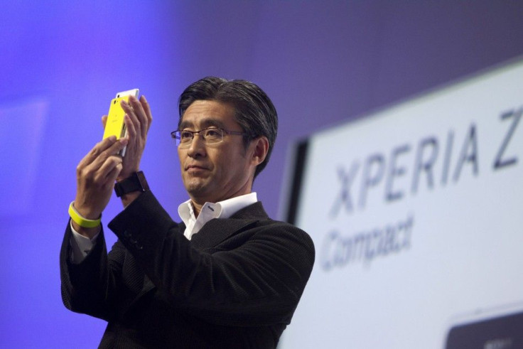 Kunimasa Suzuki, president and CEO of Sony Mobile Communications, compares the size of an Xperia Z1 Smartphone with a new smaller Xperia Z1 Compact