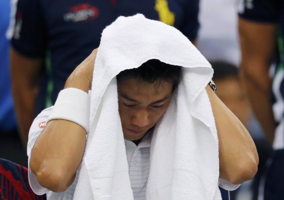 Kei Nishikori of Japan towels off during a break 
