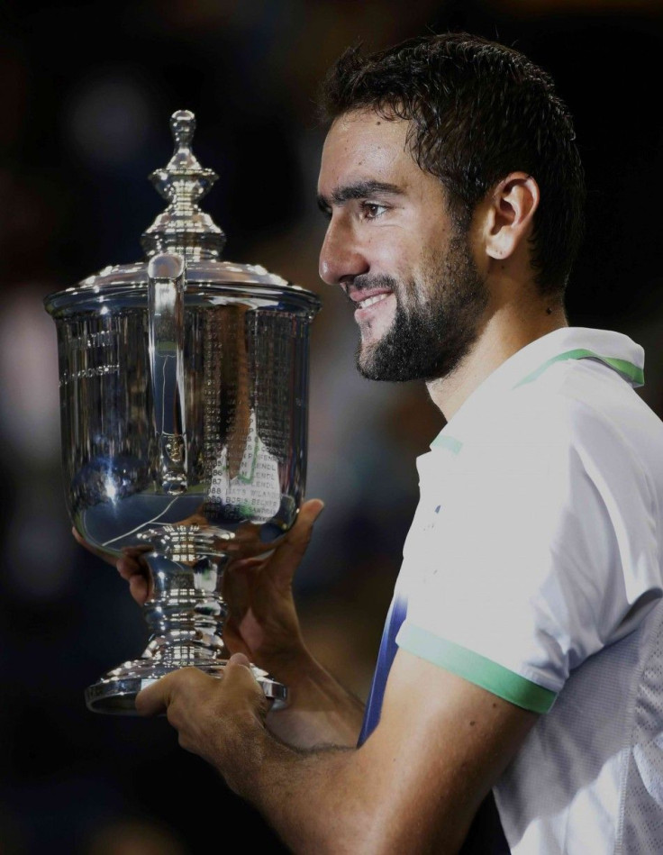 Marin Cilic of Croatia poses with his trophy after defeating Kei Nishikori of Japan in their men's singles final match at the 2014 U.S. Open tennis tournament in New York, September 8, 2014. REUTERS/Mike Segar 