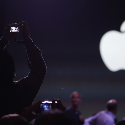 An audience member takes a photo before the Apple event announcing the iPhone 6 and the Apple Watch at the Flint Center in Cupertino