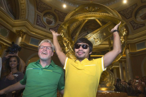 Trainer Freddie Roach (L) and boxer Manny Pacquiao of the Philippines pose in the lobby of the Venetian Las Vegas Resort in Nevada August 30, 2014. Pacquiao and his opponent Chris Algieri of the U.S. are on an international tour promoting their WBO welter
