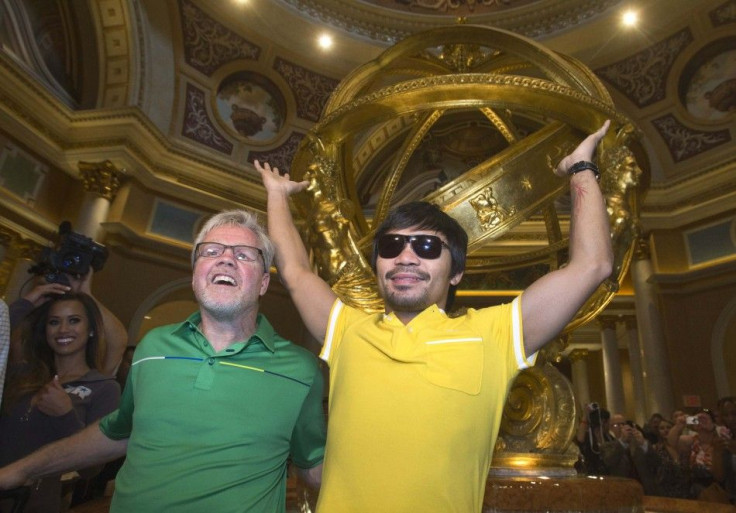 Trainer Freddie Roach (L) and boxer Manny Pacquiao of the Philippines pose in the lobby of the Venetian Las Vegas Resort in Nevada August 30, 2014. Pacquiao and his opponent Chris Algieri of the U.S. are on an international tour promoting their WBO welter