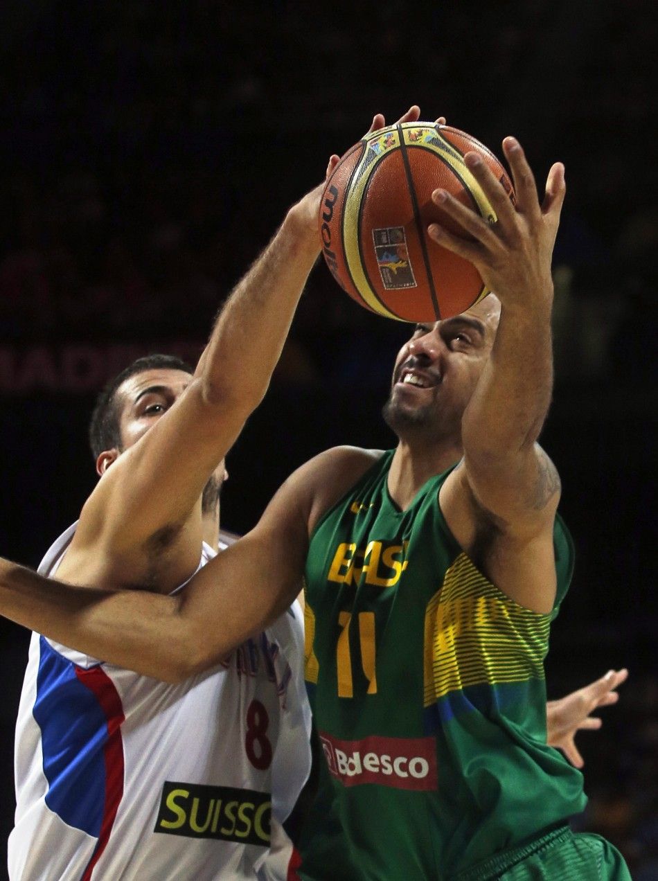 Brazils Marquinhos Vieira R is blocked by Serbias Nemanja Bjelica 