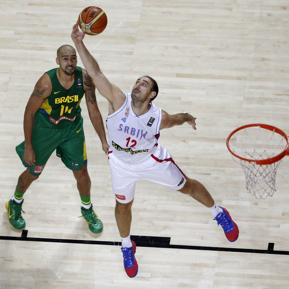 Nenad Krstic R of Serbia challenges Marquinhos Vieira of Brazil 